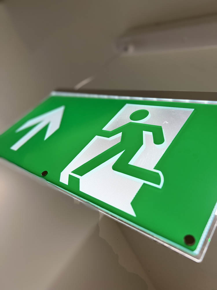 Green fire exit sign with arrow